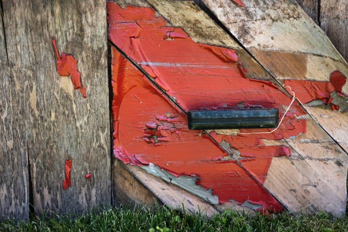 Rustic wooden corner with red paint splash