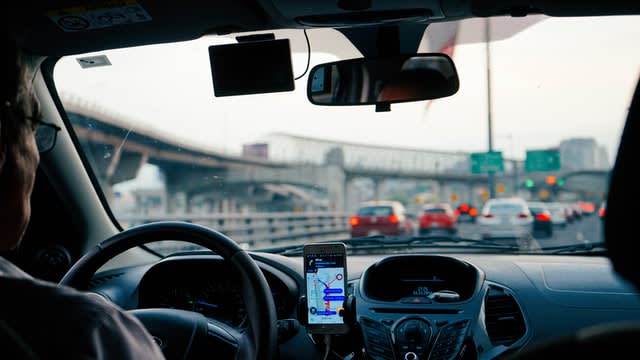 Rideshare driver with map on phone