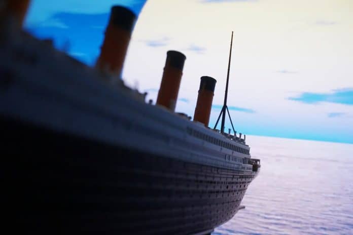 Up-close shot of Titanic model ship over water