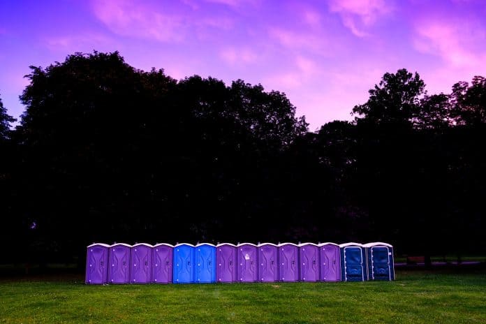 Row of purple and blue porta-potties outside