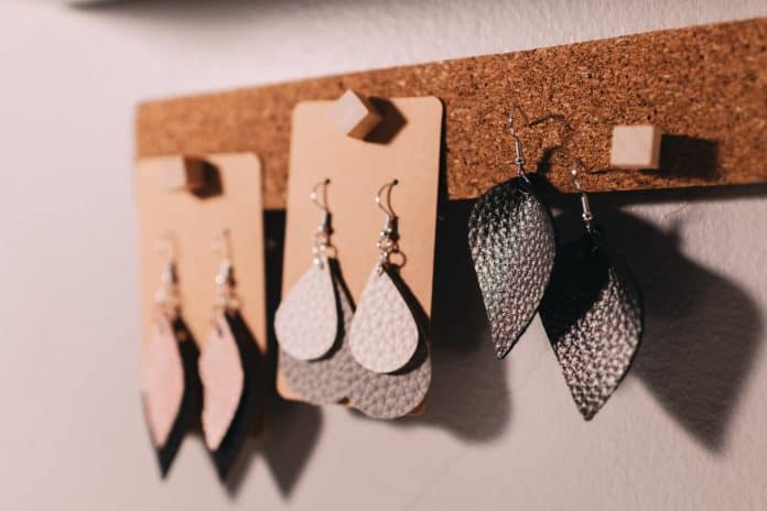Leather earrings hanging on cork board