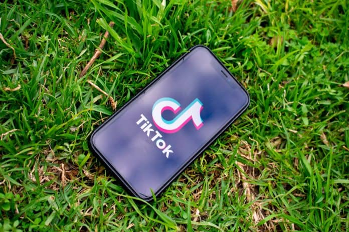 iPhone with TikTok app open on the screen