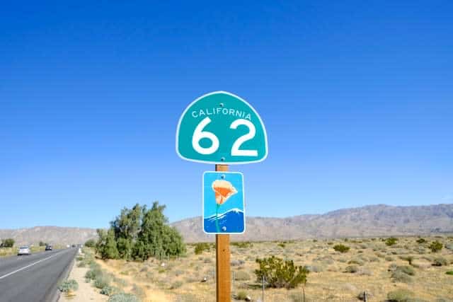 California highway 62 sign, with road in background