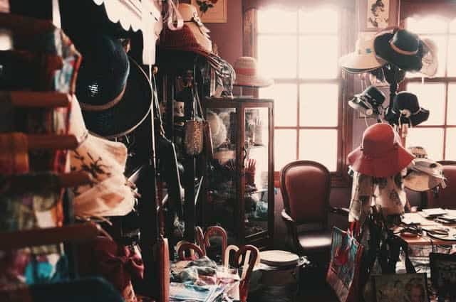 Cluttered room with hats, purses, glasses cases, all full of stuff