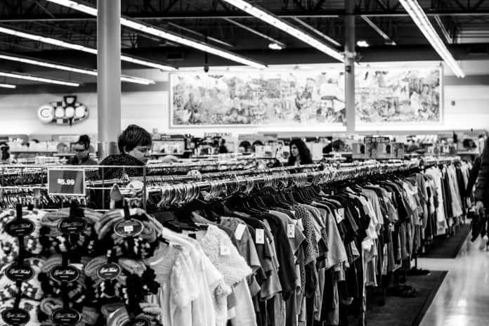 Black and white photo of people shopping in thrift store
