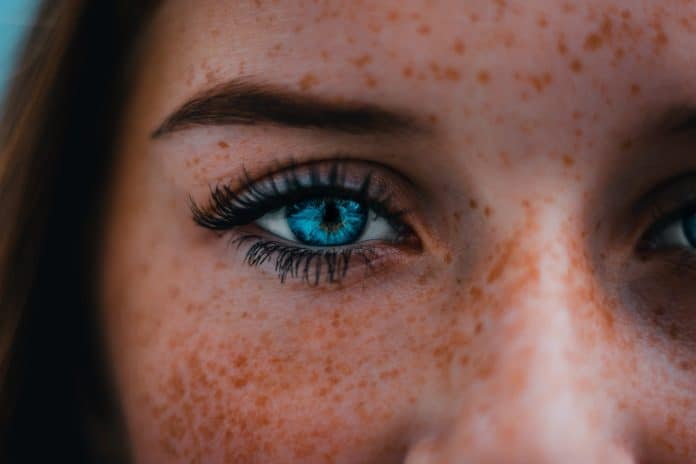 Close-up of freckled woman's eyes