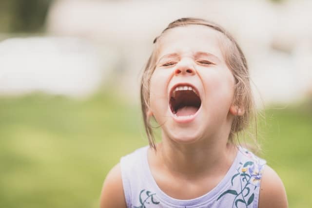 Kid laughing with mouth wide open